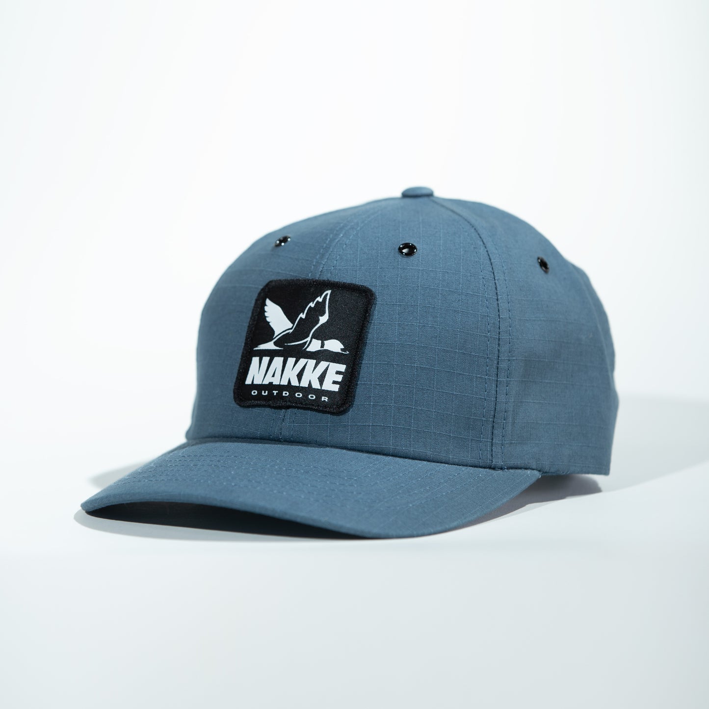 A Blue Outdoor Strapback Hat with the Black and White Nakke Duck Logo Patch