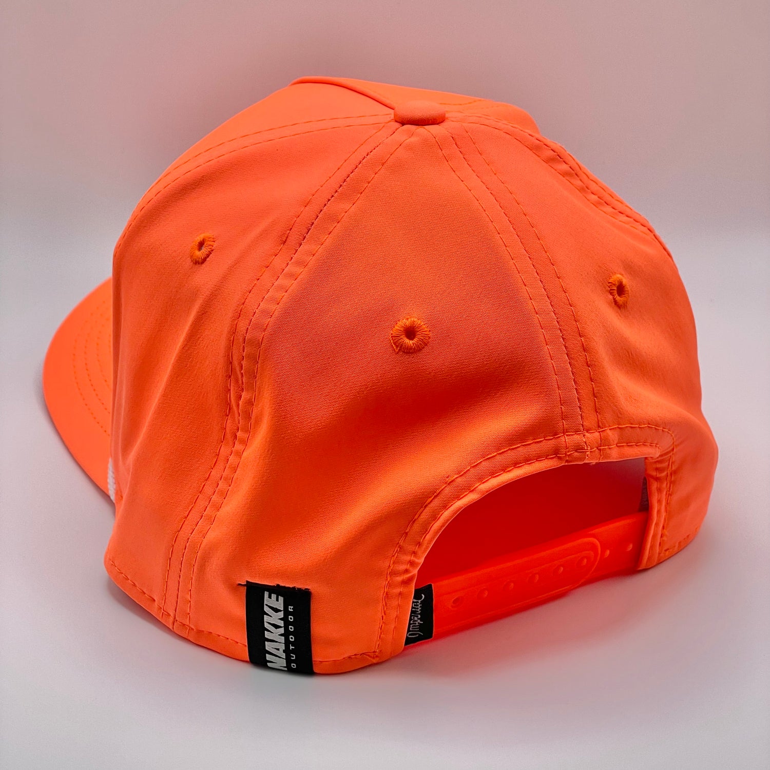 Neon Orange Retro Fit Hat with a black embroidered fish and white woven rope