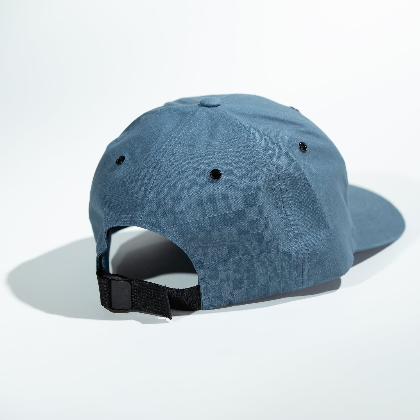 A Blue Outdoor Strapback Hat with the Black and White Nakke Duck Logo Patch